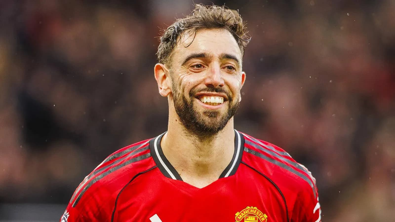 Player smiling in Manchester United jersey during match Player smiling in Manchester United jersey during match