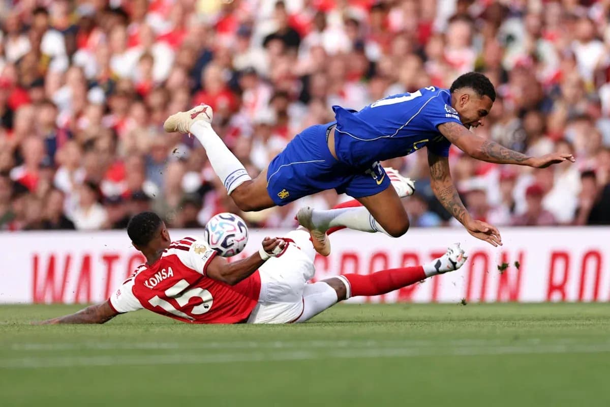 Player tackling another during a football match Player tackling another during a football match