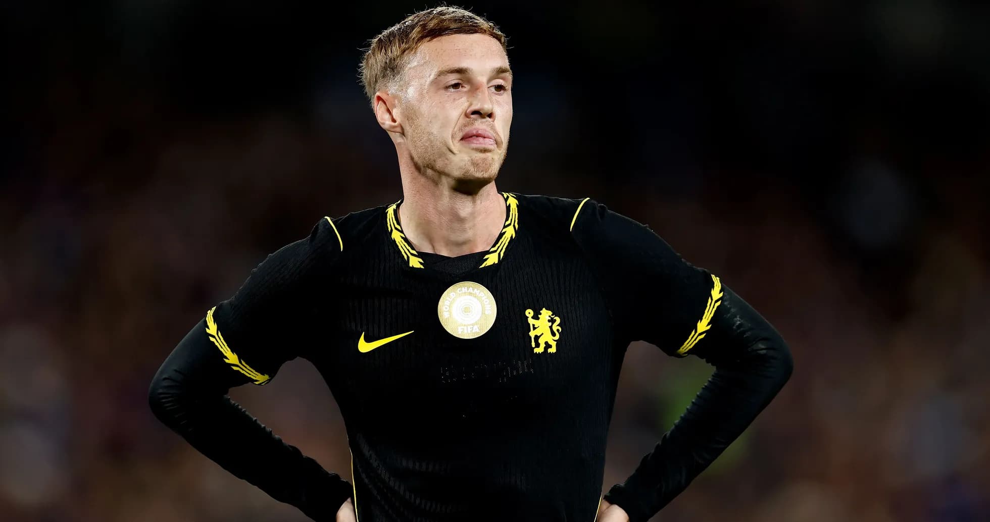 Player in black kit during match with Chelsea emblem Player in black kit during match with Chelsea emblem