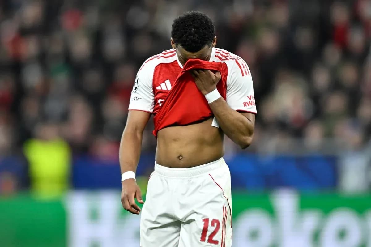 Player looking down, holding jersey after match Player looking down, holding jersey after match