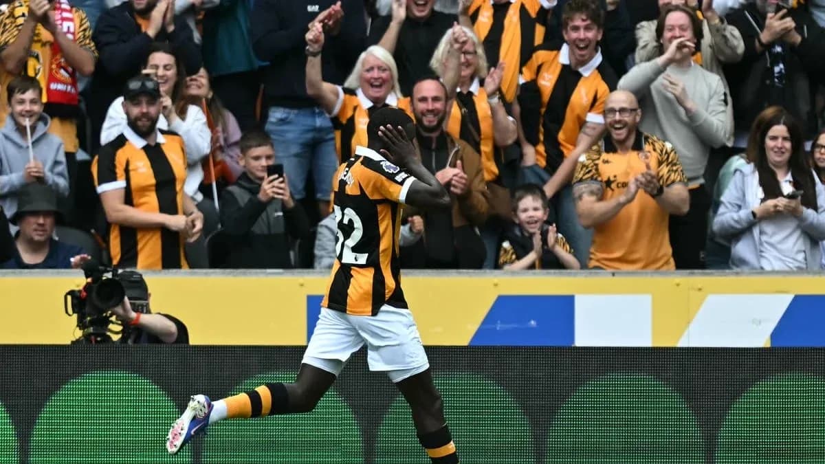 Player celebrating a goal with cheering fans Player celebrating a goal with cheering fans