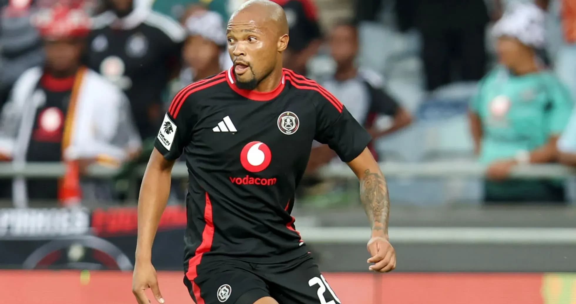 Player in black jersey running on the pitch Player in black jersey running on the pitch