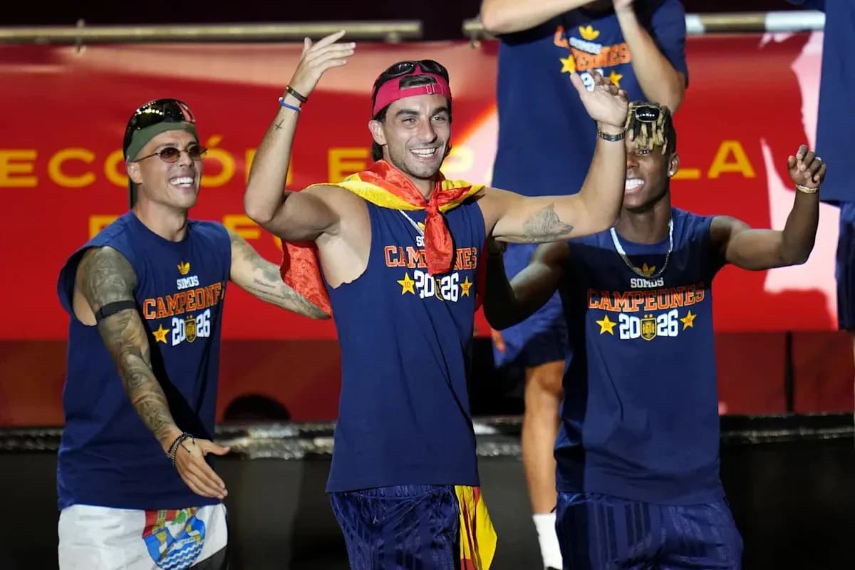 Players celebrating on stage with trophies and flags Players celebrating on stage with trophies and flags