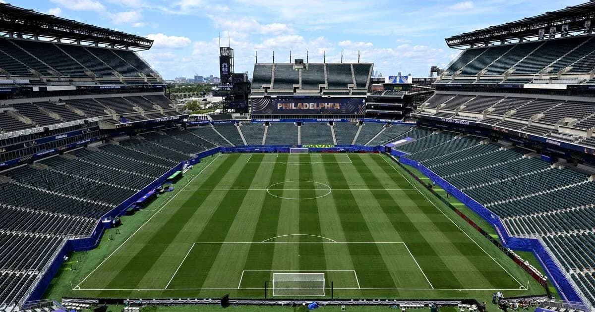 Empty soccer stadium with field and seating areas Empty soccer stadium with field and seating areas