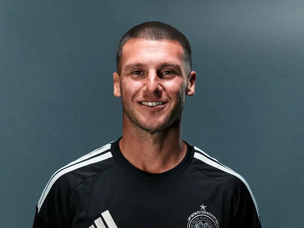 Player posing in team jersey against gray background Player posing in team jersey against gray background