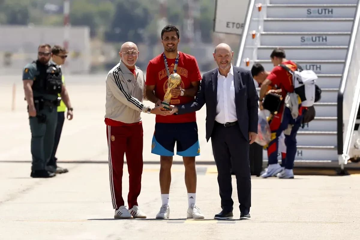 Player receiving trophy at airport arrival ceremony Player receiving trophy at airport arrival ceremony
