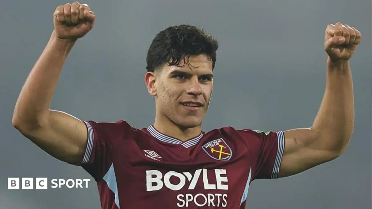 Player celebrating with raised fists in West Ham kit Player celebrating with raised fists in West Ham kit