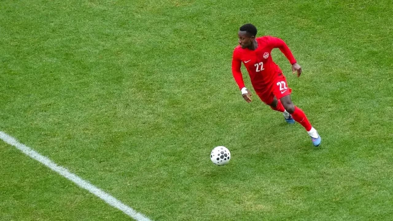 Player in red jersey running after the ball Player in red jersey running after the ball