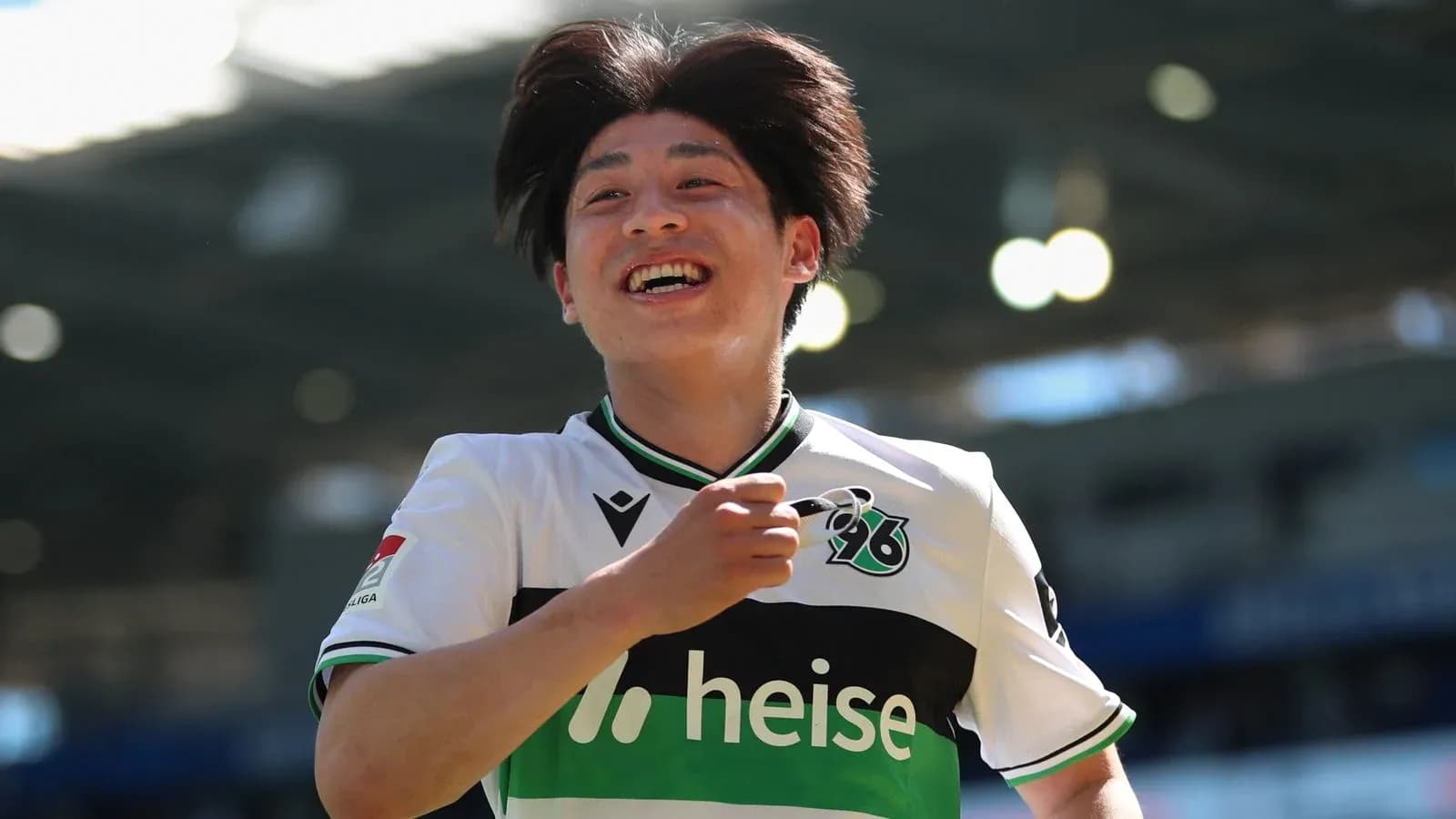 Player celebrating with a smile after scoring Player celebrating with a smile after scoring