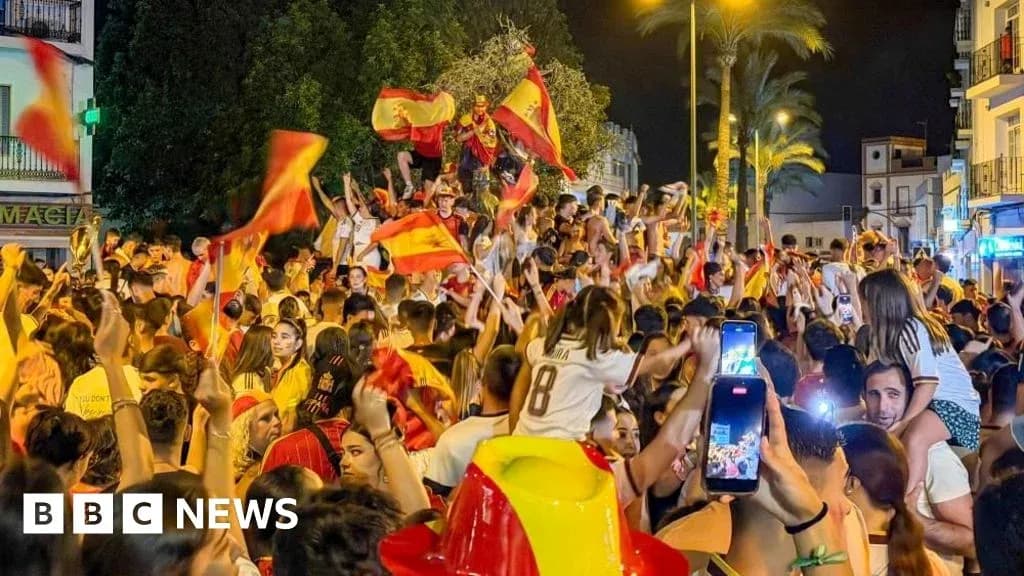 Crowd celebrating with flags in nighttime street Crowd celebrating with flags in nighttime street