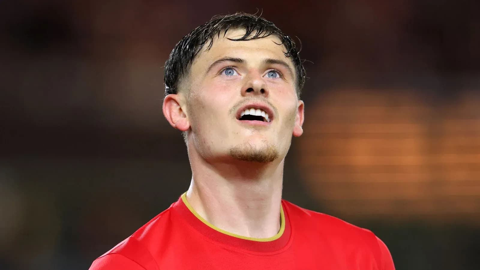 Player in red jersey looking upwards after match Player in red jersey looking upwards after match