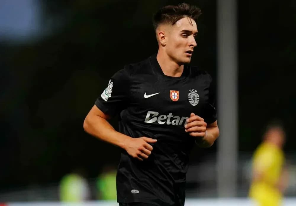 Player running on field in black sports kit Player running on field in black sports kit