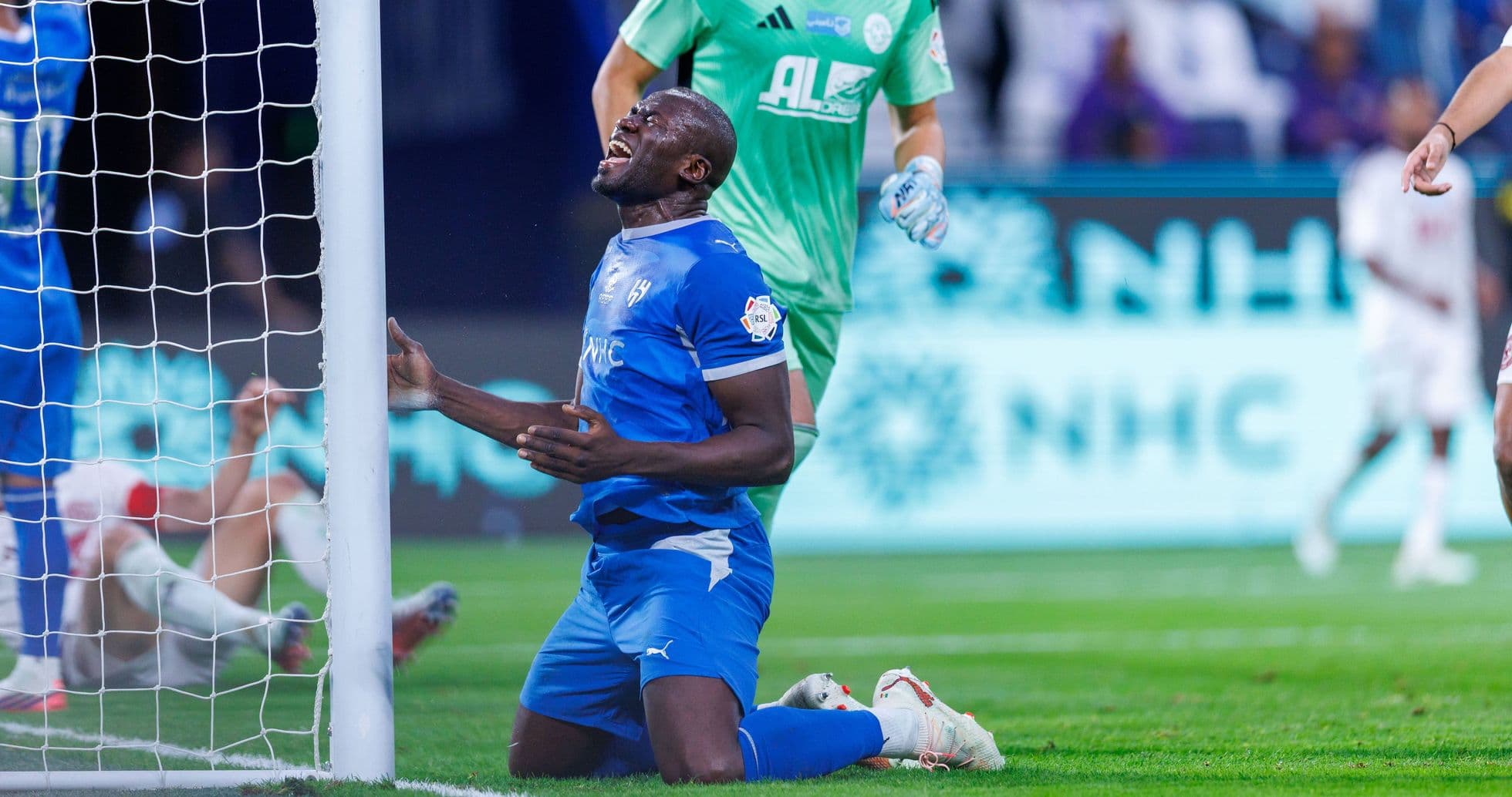 Player on knees near goalpost after missed opportunity Player on knees near goalpost after missed opportunity