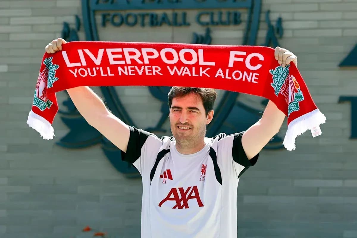 Man holding Liverpool FC scarf at club announcement Man holding Liverpool FC scarf at club announcement