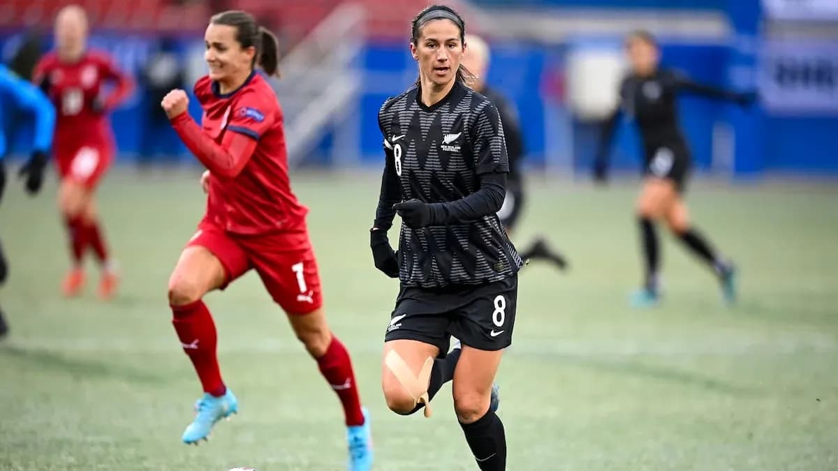 Two players running during a soccer match Two players running during a soccer match