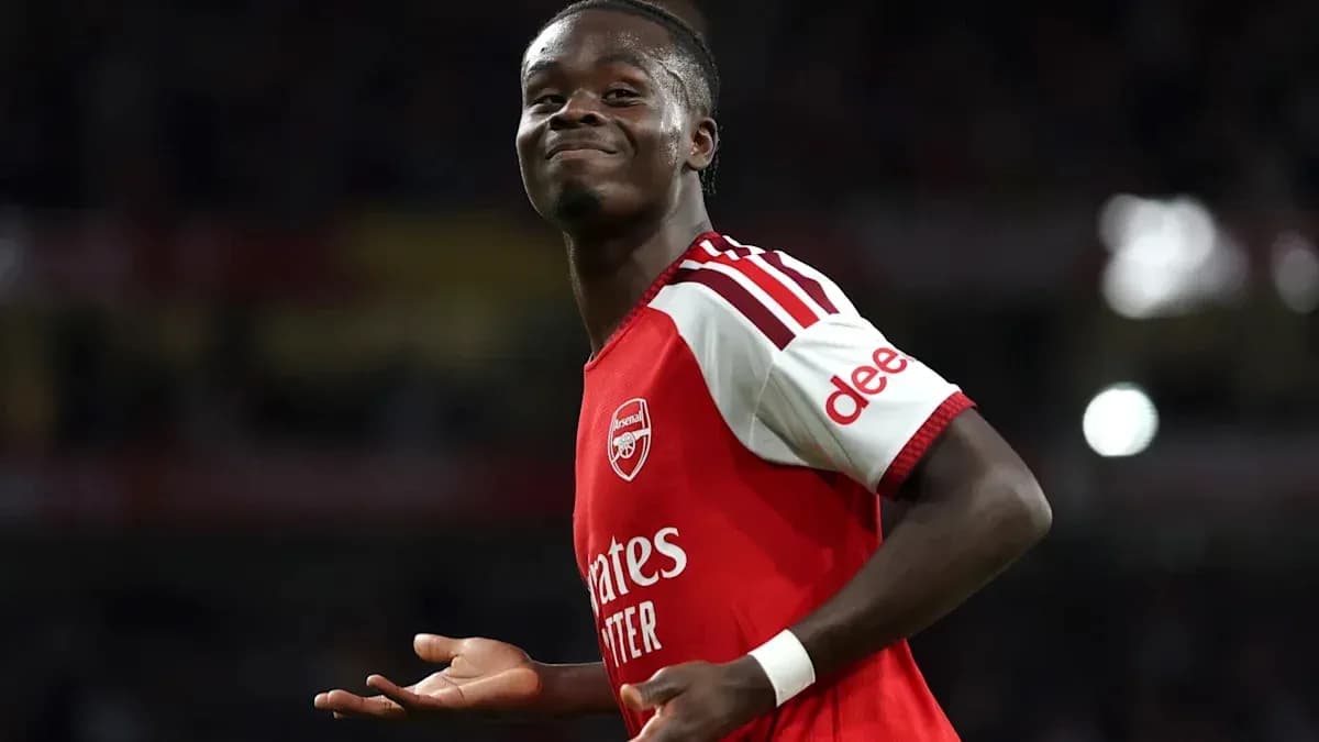 Player celebrating during a match in Arsenal kit Player celebrating during a match in Arsenal kit