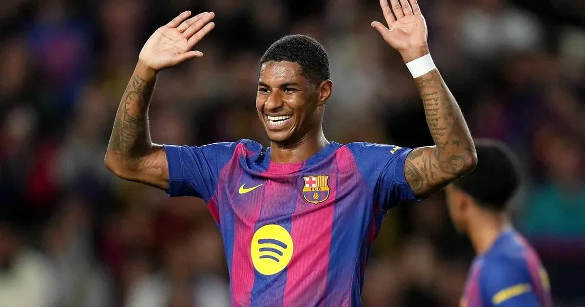Player celebrating with arms raised during match Player celebrating with arms raised during match