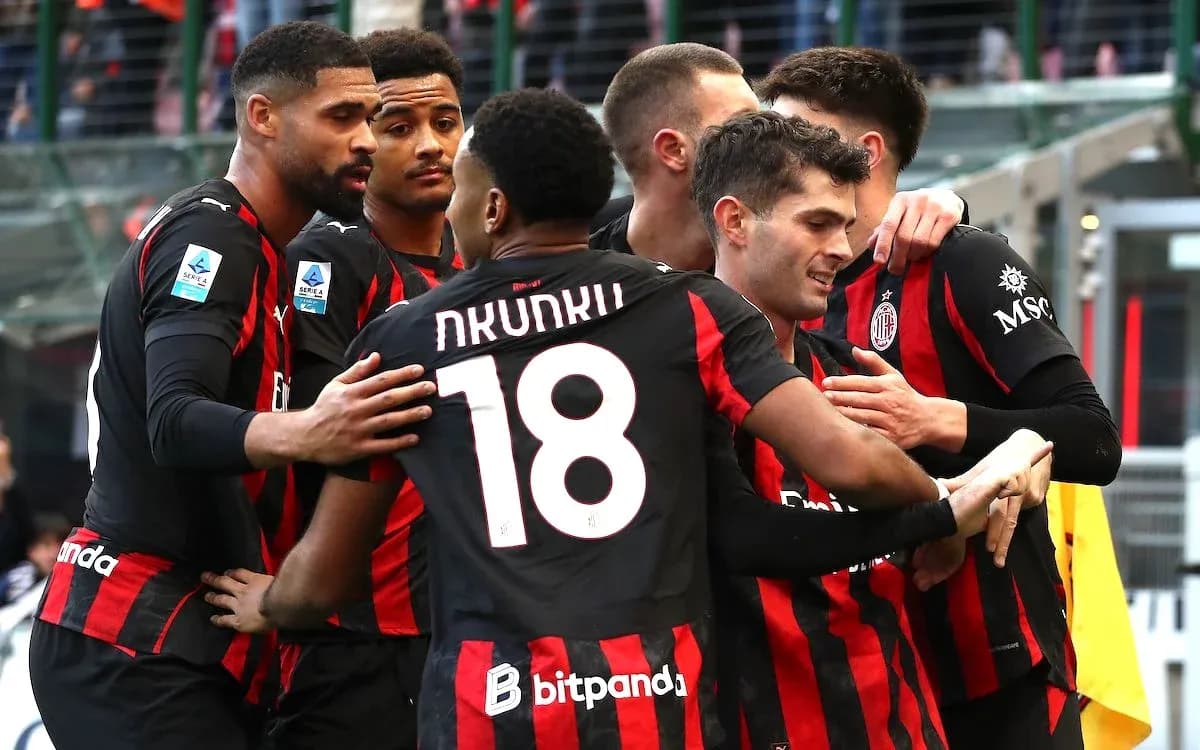 AC Milan players celebrating a goal together AC Milan players celebrating a goal together