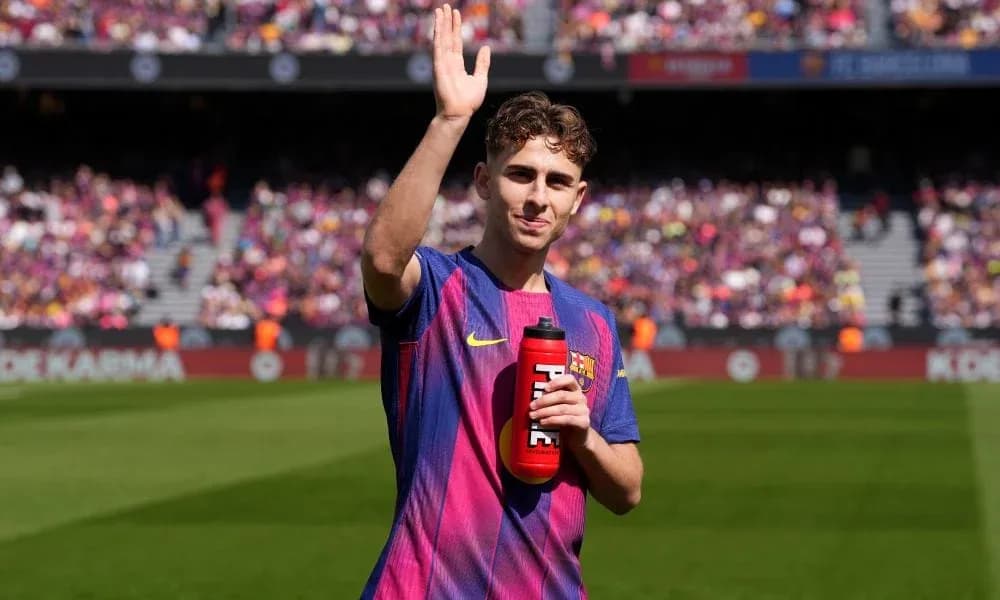 Player waving while holding a water bottle Player waving while holding a water bottle