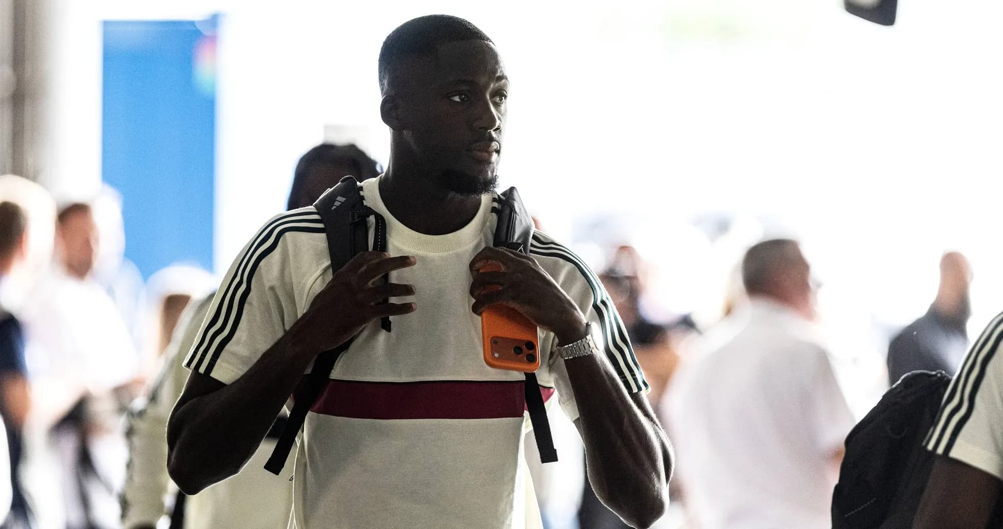 Player arriving at venue holding a phone Player arriving at venue holding a phone