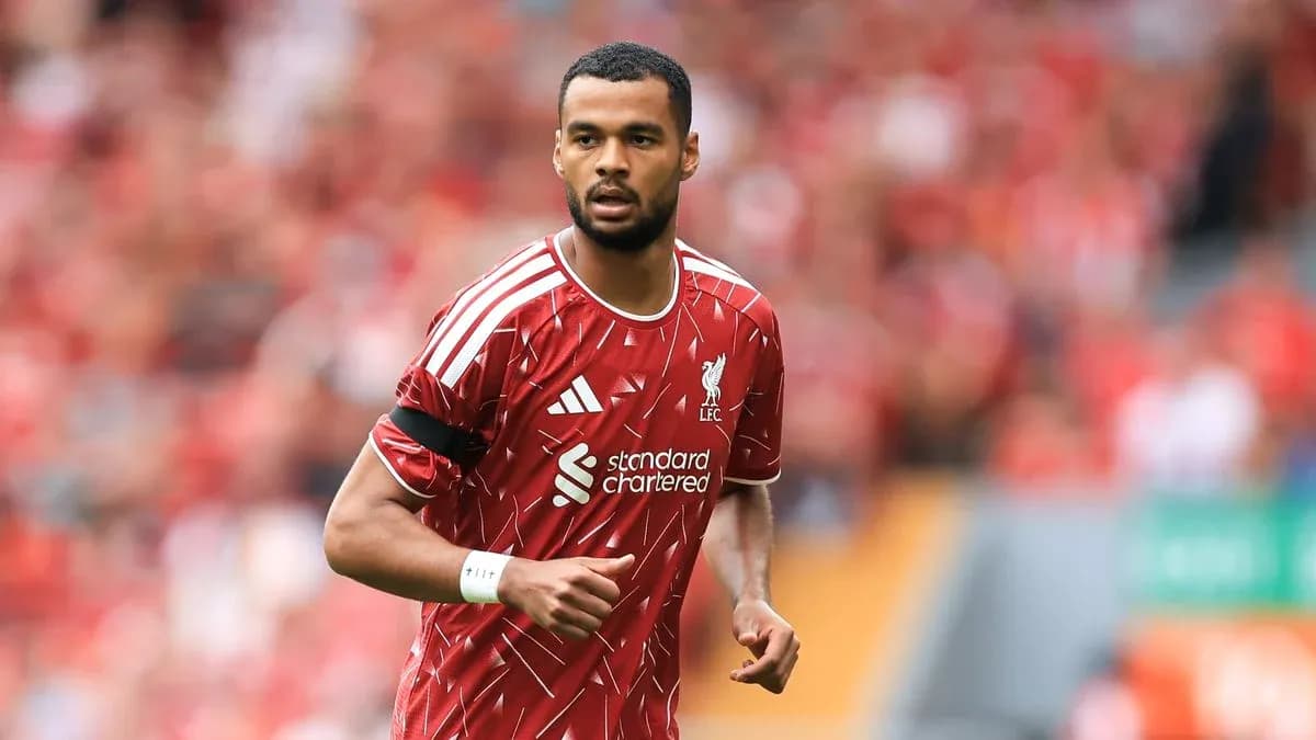Player in Liverpool kit running on the pitch Player in Liverpool kit running on the pitch