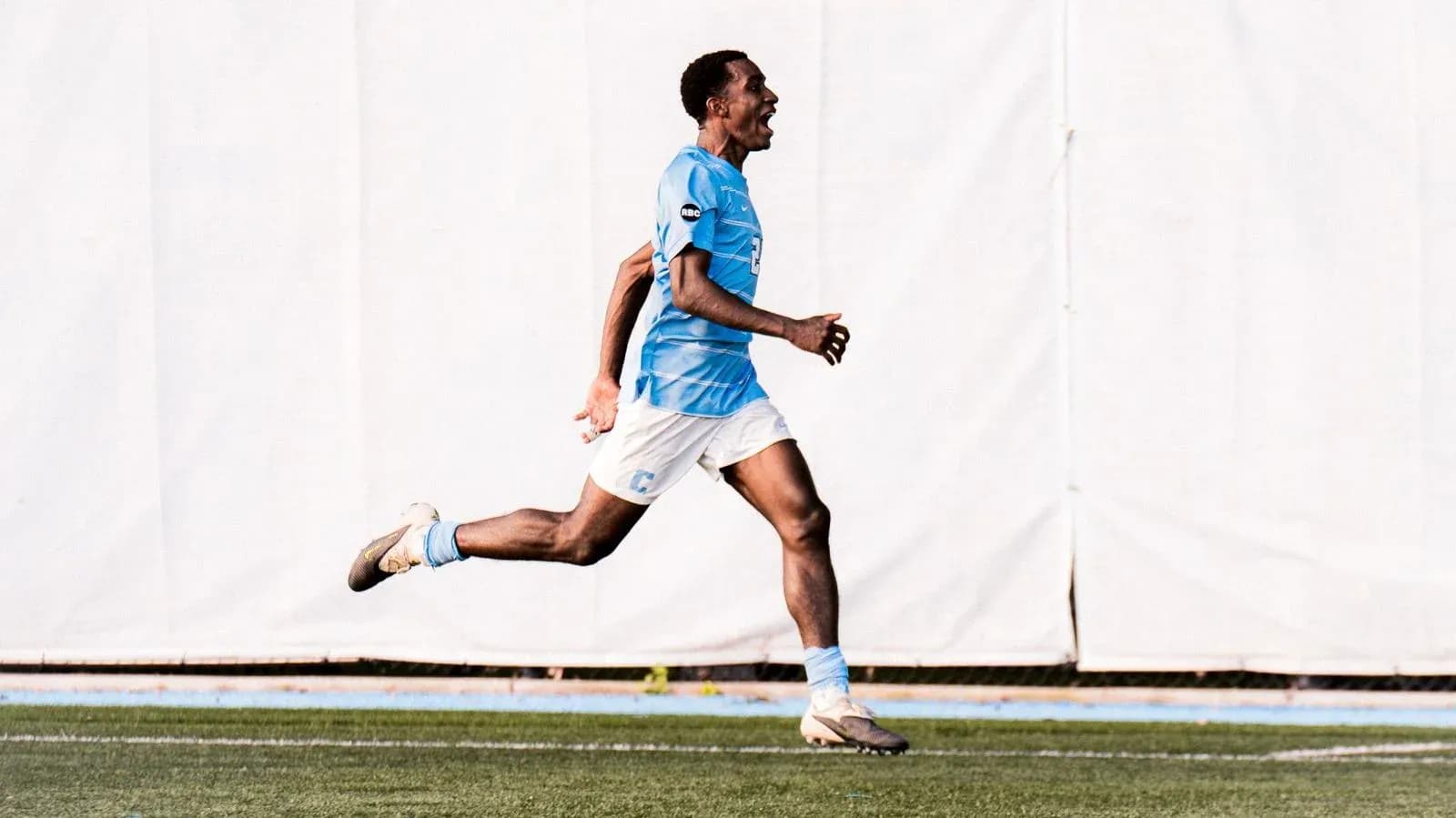 Player celebrating a goal while running on the field Player celebrating a goal while running on the field