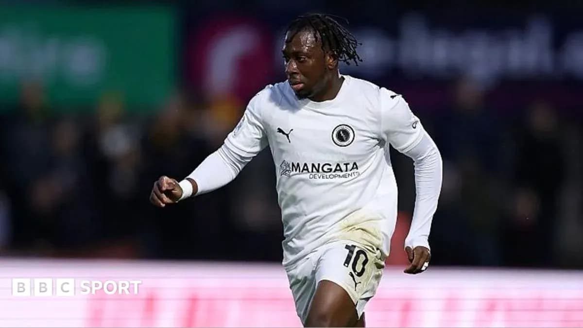 Player in white kit celebrating during match Player in white kit celebrating during match
