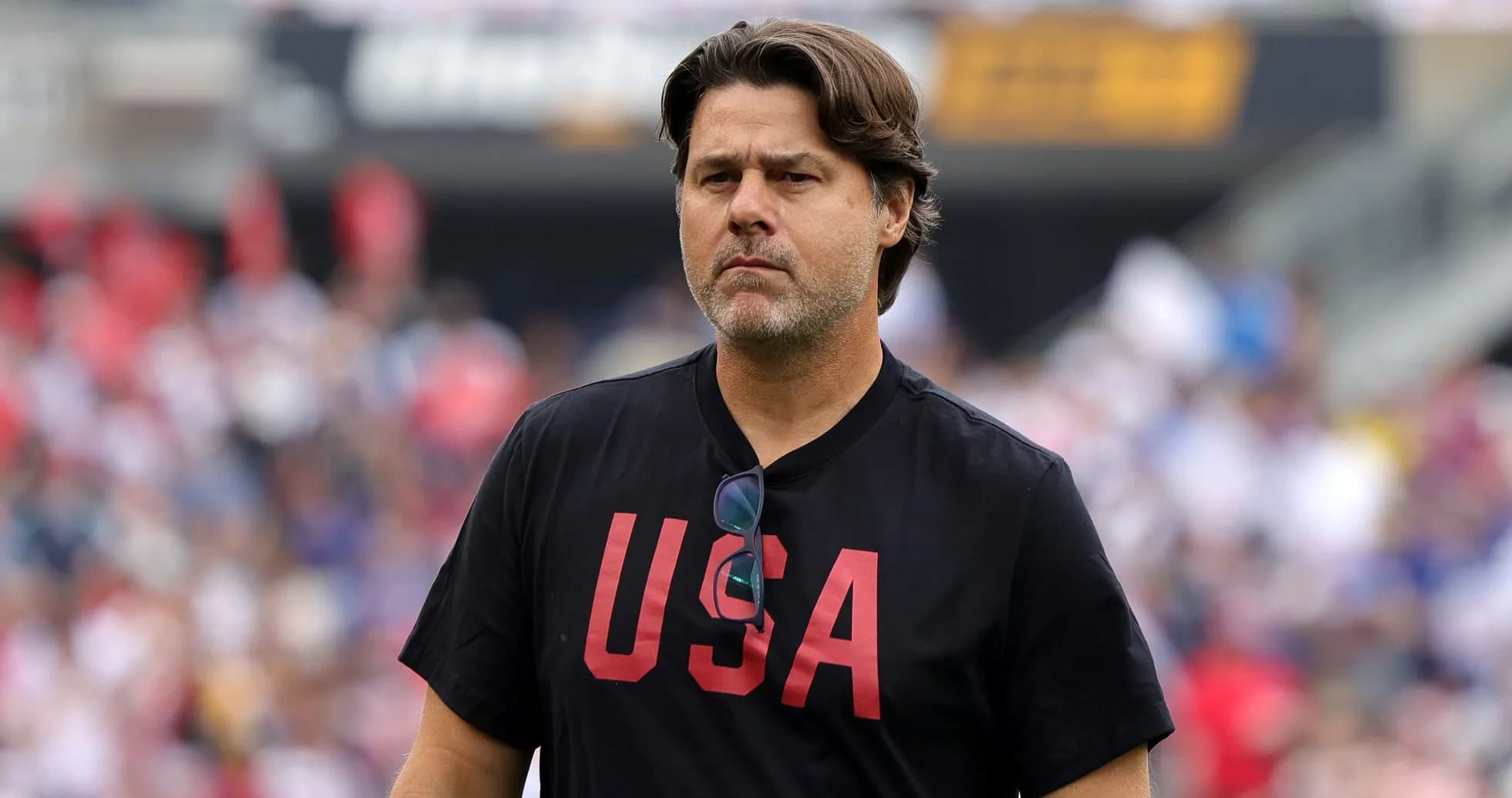 Coach wearing 'USA' shirt on the field Coach wearing 'USA' shirt on the field