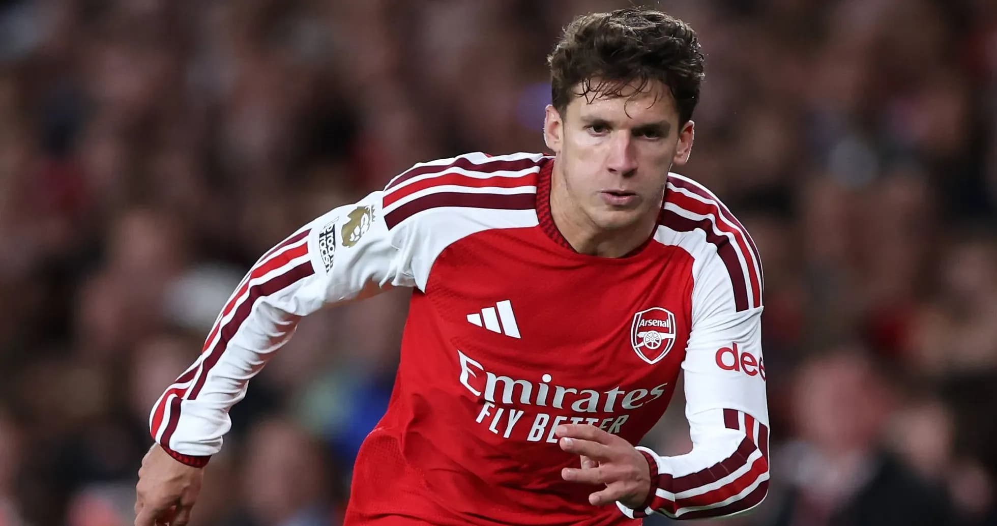 Player running during match in Arsenal kit Player running during match in Arsenal kit