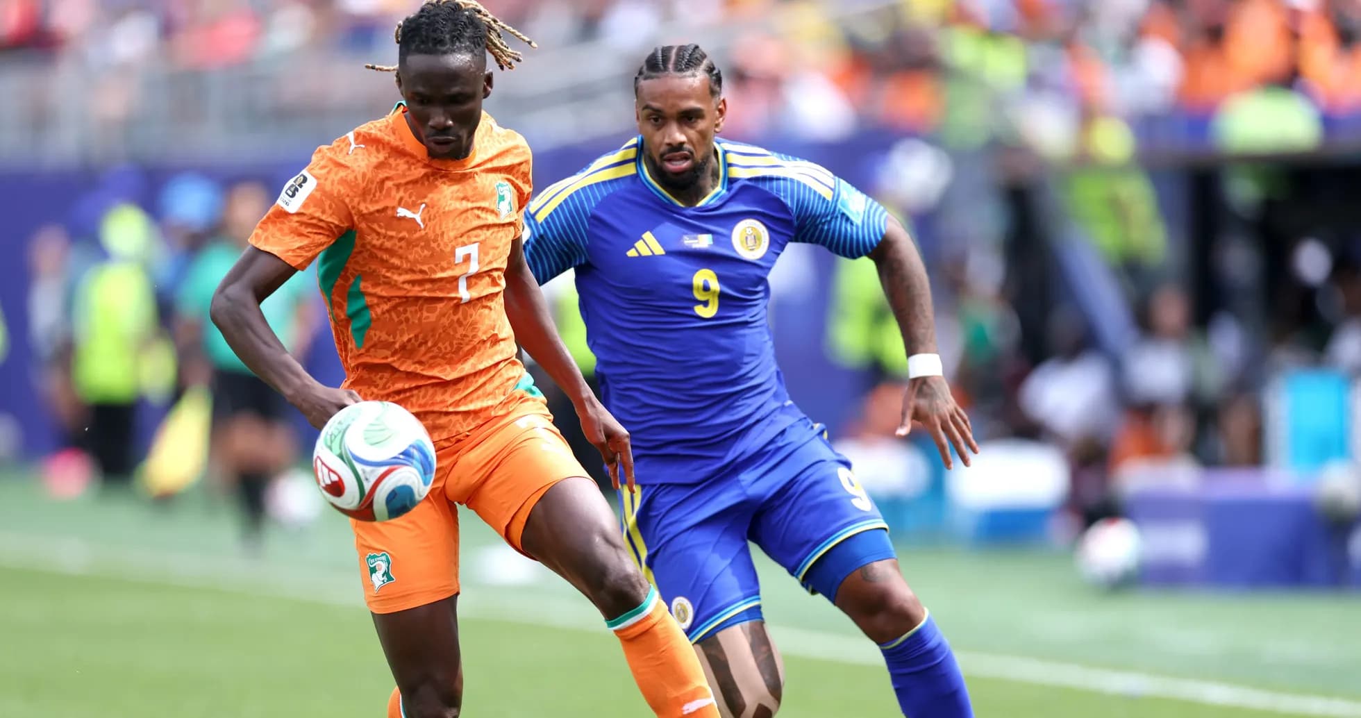 Player from Ivory Coast dribbling past opponent Player from Ivory Coast dribbling past opponent