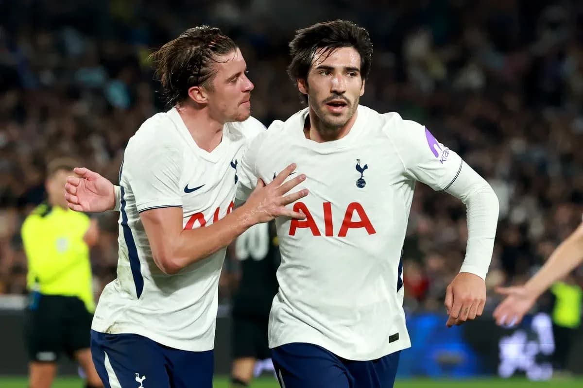 Two Tottenham players celebrating a goal together Two Tottenham players celebrating a goal together