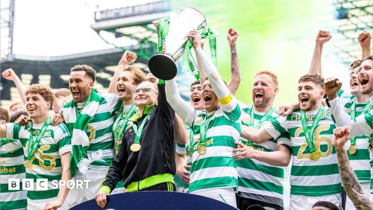 Celtic players celebrating with trophy after victory Celtic players celebrating with trophy after victory