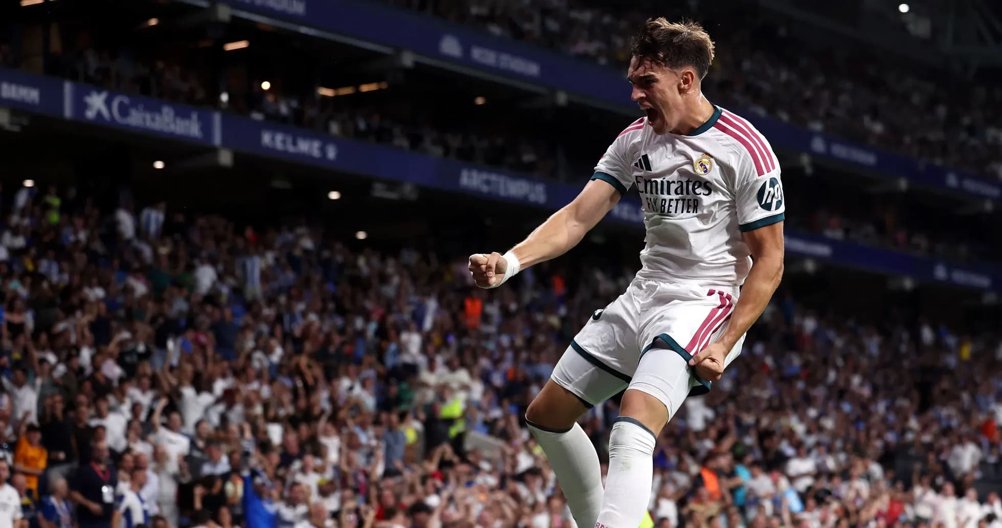 Player celebrating a goal at stadium with fans Player celebrating a goal at stadium with fans