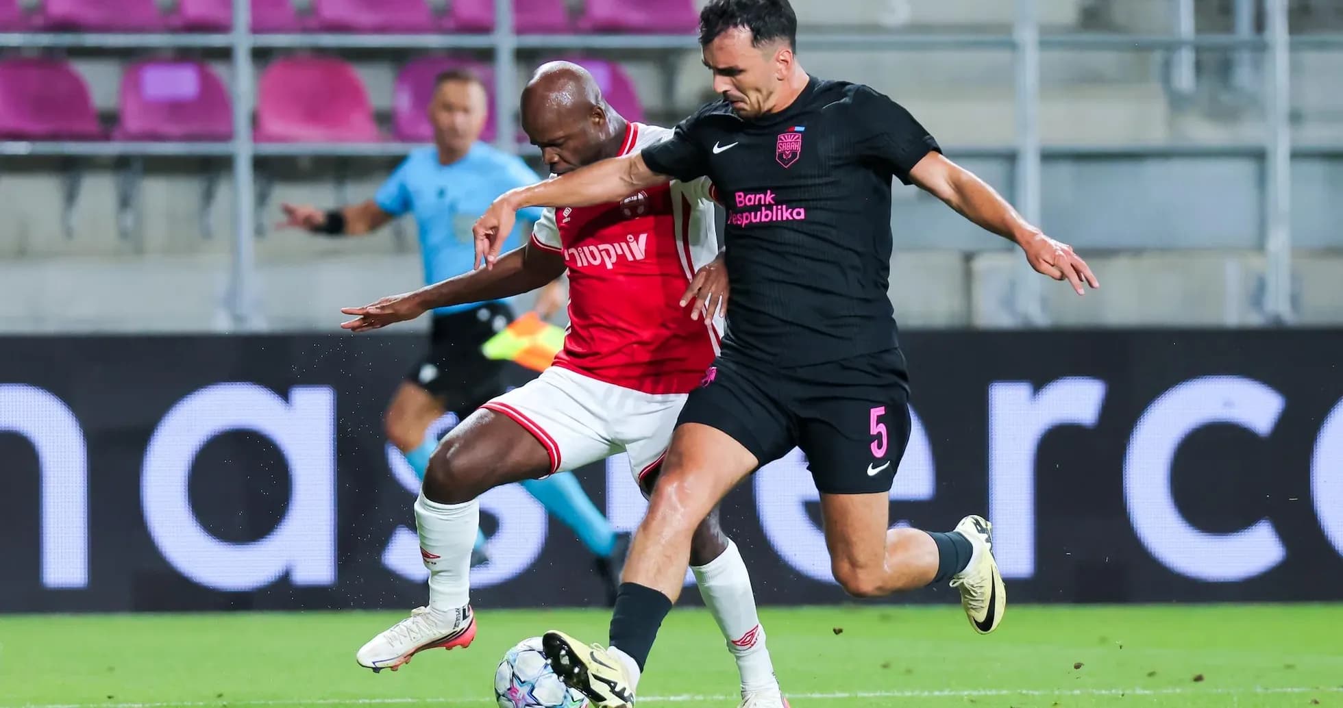 Players competing for the ball in UEFA match Players competing for the ball in UEFA match