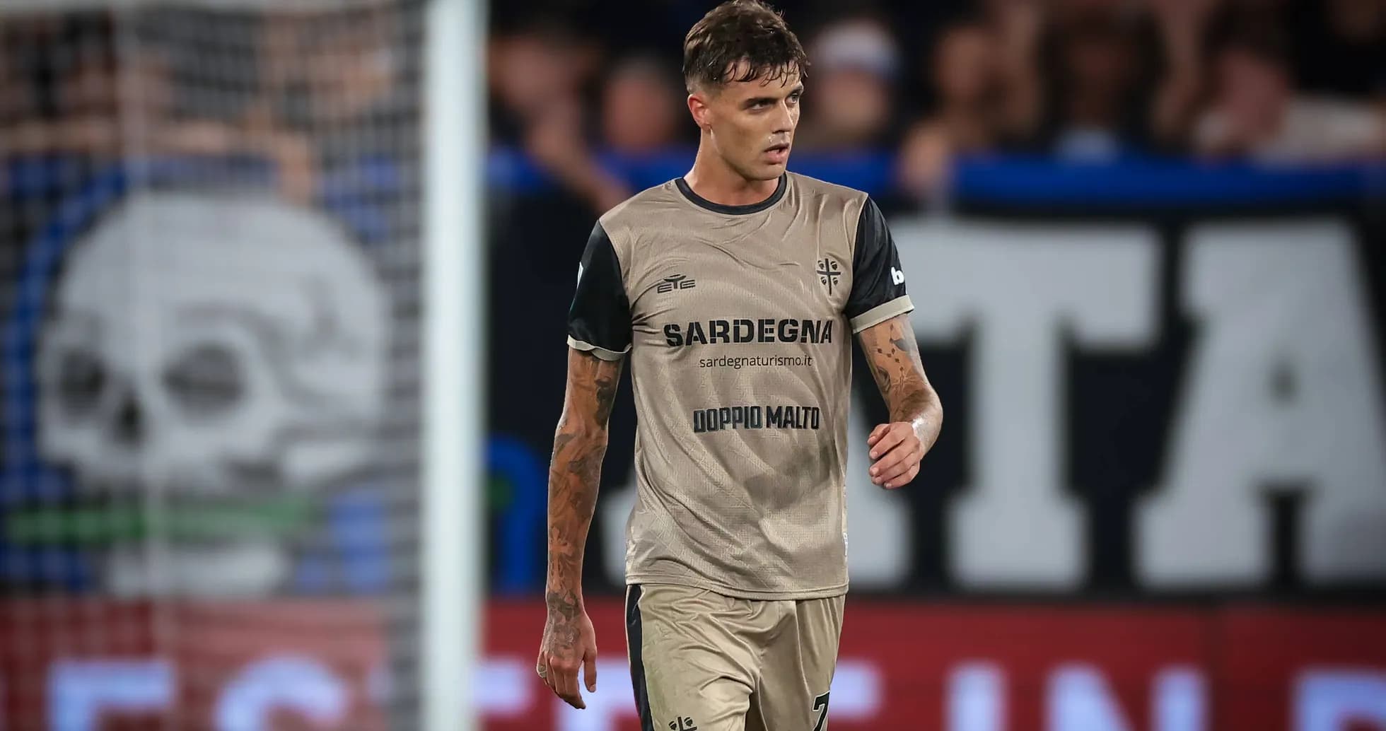 Player walking on the pitch in match attire Player walking on the pitch in match attire