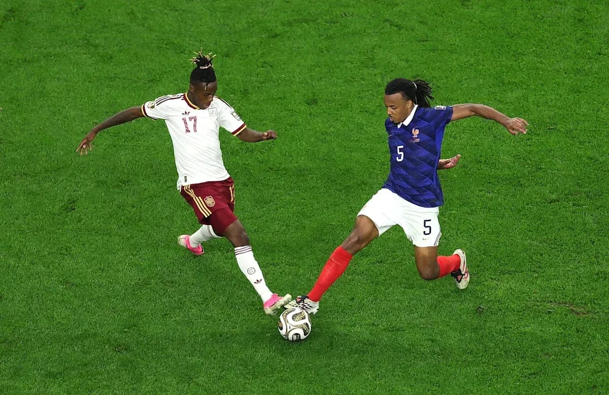 Two players contesting for the ball during match Two players contesting for the ball during match