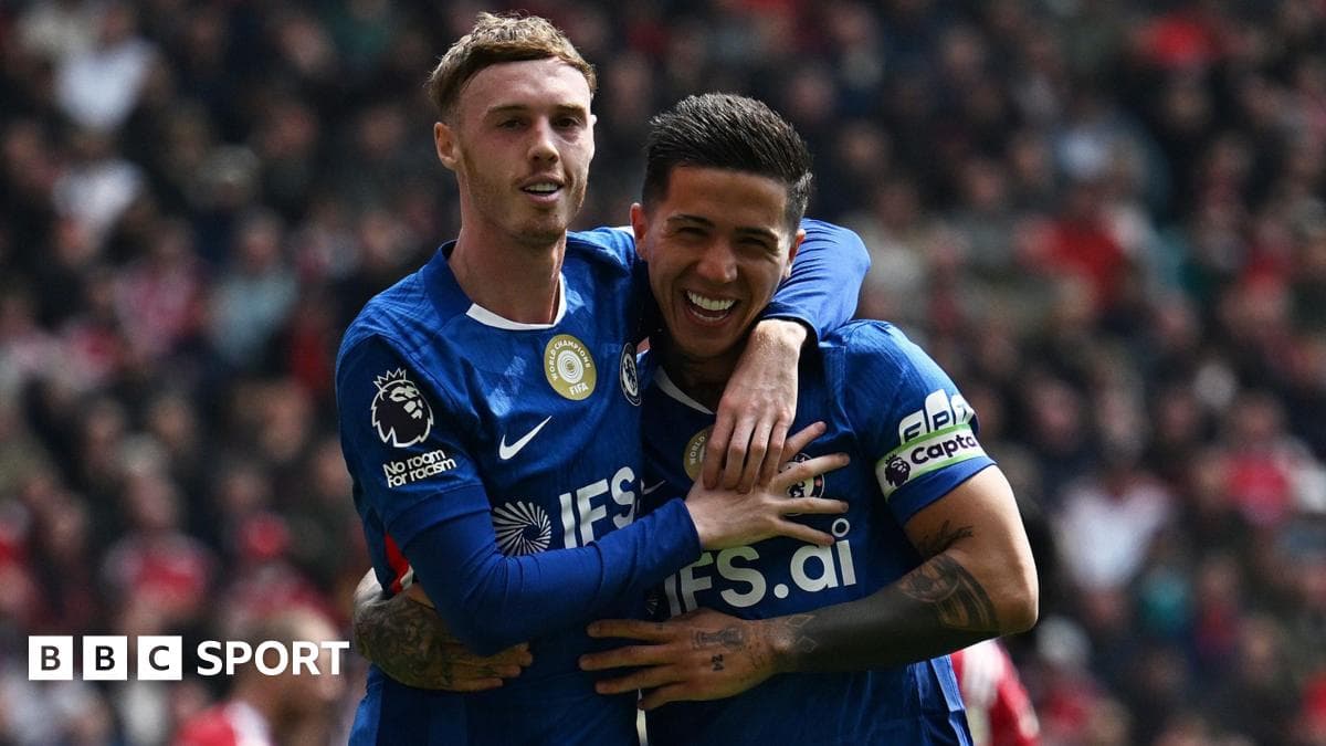 Two players celebrating a goal on the field Two players celebrating a goal on the field