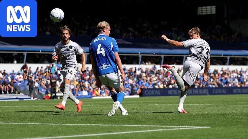 Player kicking ball during match with defenders nearby Player kicking ball during match with defenders nearby