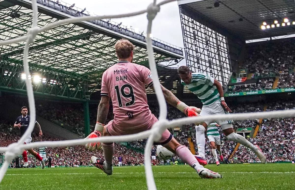 Goalkeeper Bain attempting to block a shot on goal Goalkeeper Bain attempting to block a shot on goal