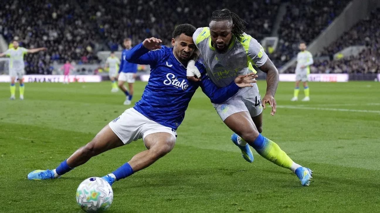 Two players competing for the ball on field Two players competing for the ball on field