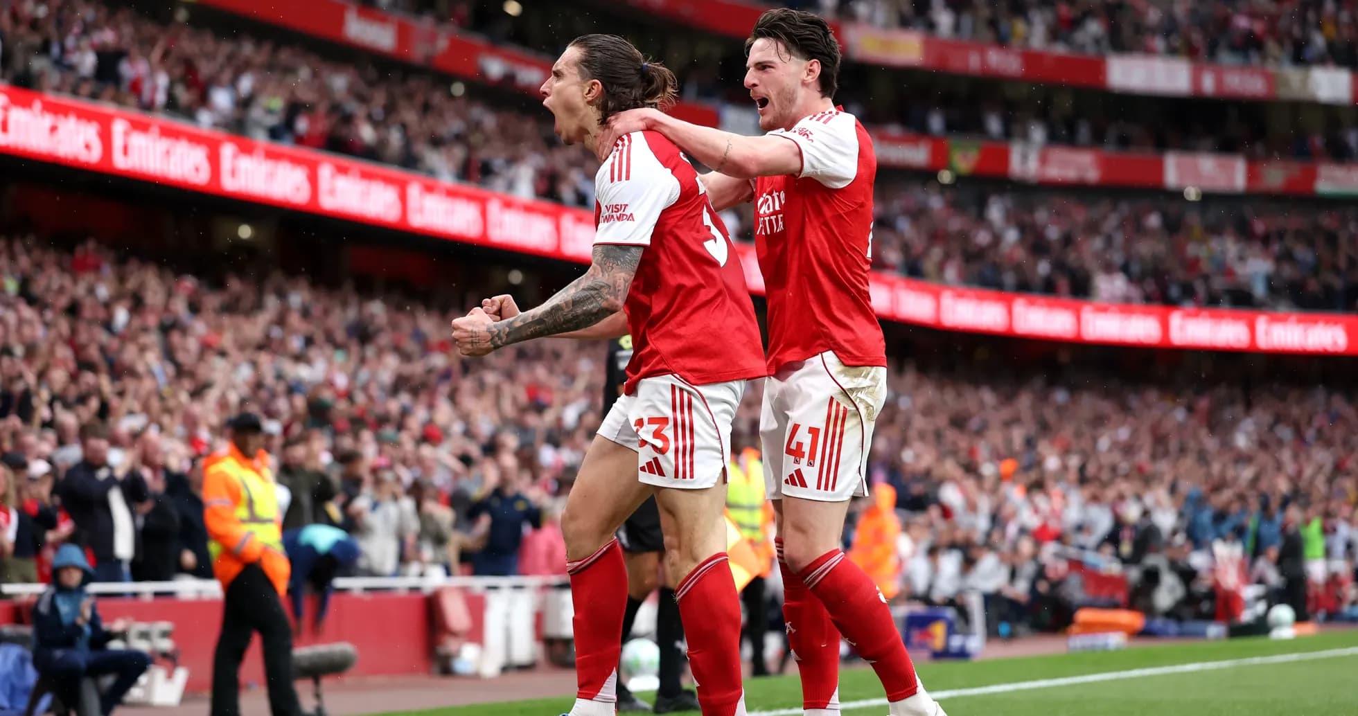 Two Arsenal players celebrating a goal at Emirates Stadium Two Arsenal players celebrating a goal at Emirates Stadium