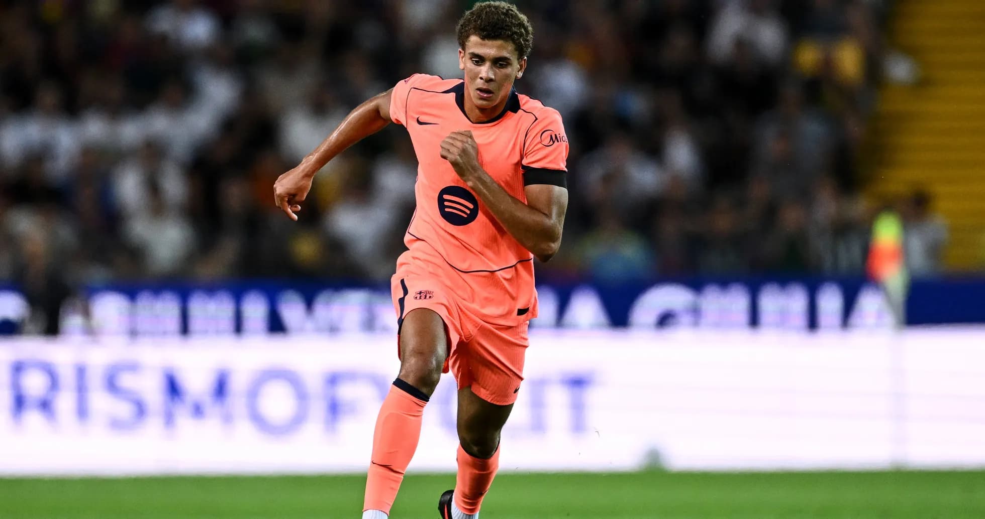 Player in pink kit sprinting during a match Player in pink kit sprinting during a match