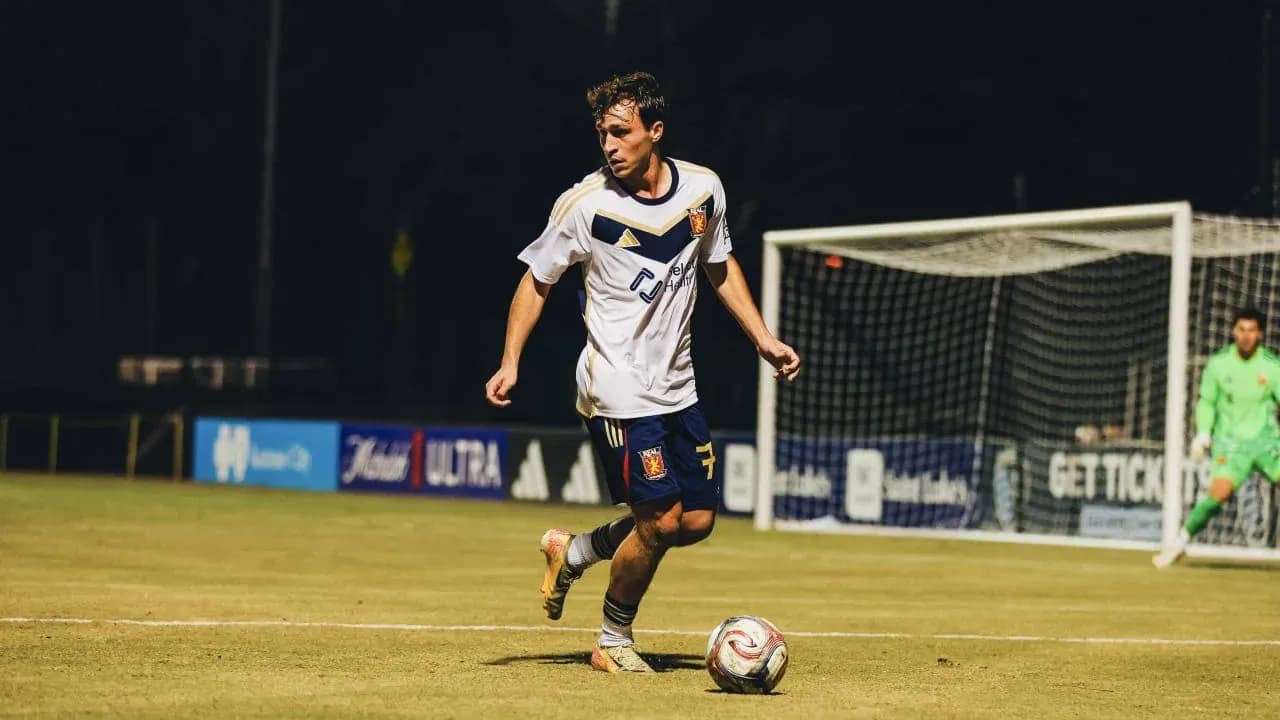 Real Monarchs player dribbling the ball Real Monarchs player dribbling the ball