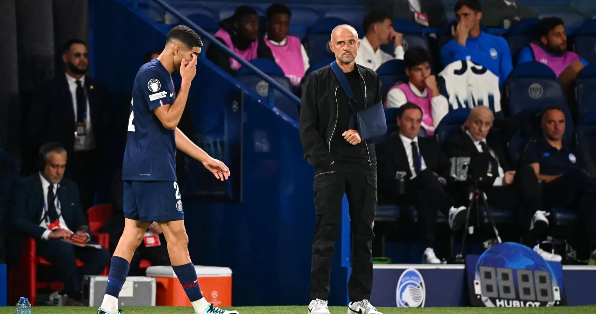 Player leaving field while coach observes during match Player leaving field while coach observes during match