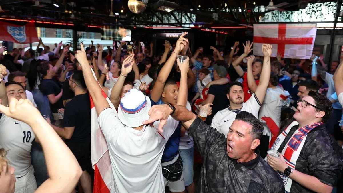 Crowd of fans celebrating in a bar during match Crowd of fans celebrating in a bar during match