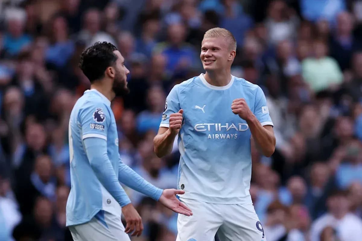 Two Manchester City players celebrating a goal Two Manchester City players celebrating a goal