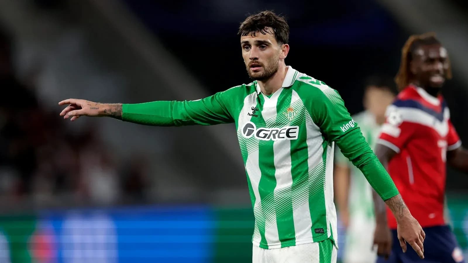 Player in green jersey gesturing during match Player in green jersey gesturing during match