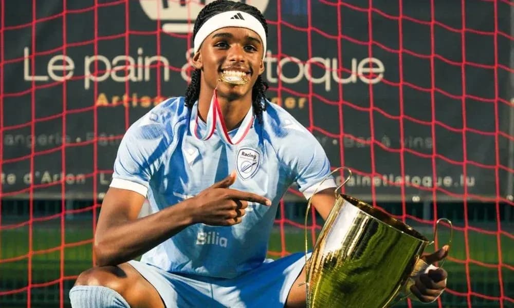 Player celebrating with trophy in front of goal Player celebrating with trophy in front of goal