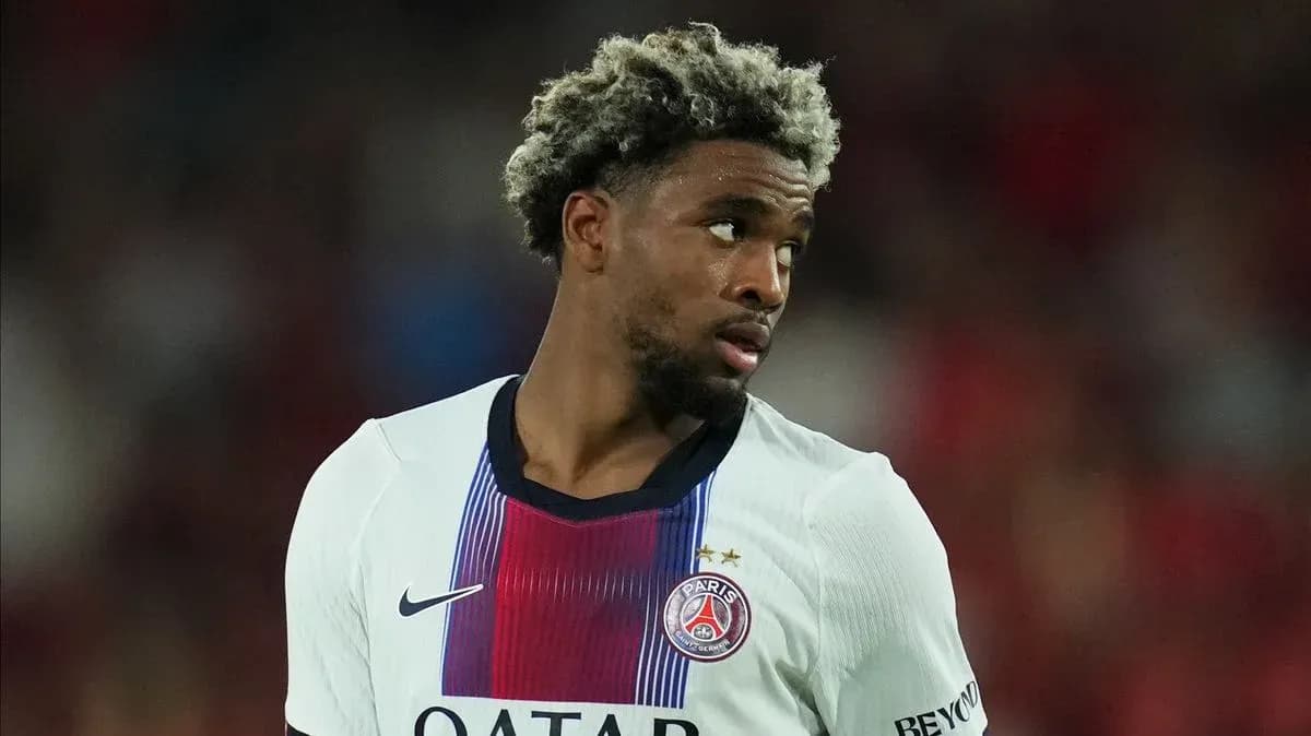 Player in PSG jersey looking away during match Player in PSG jersey looking away during match