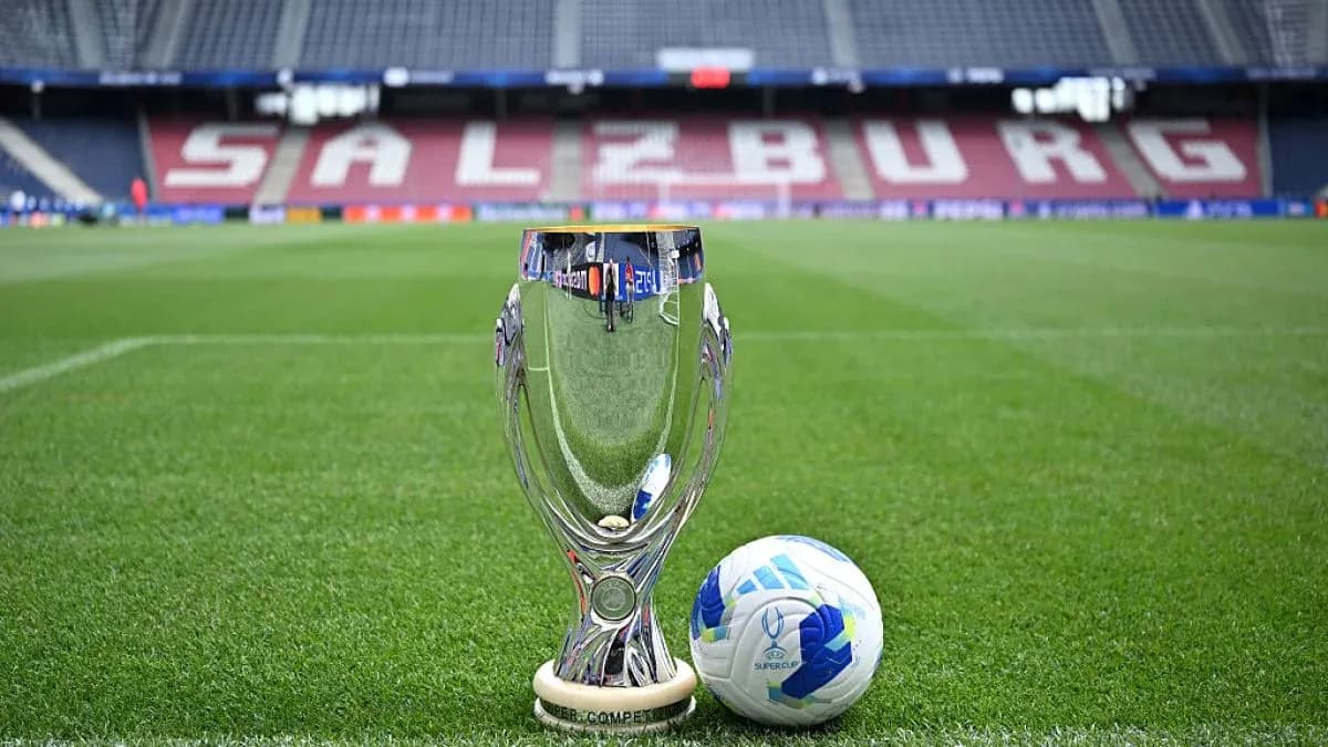 UEFA Super Cup trophy and ball on pitch UEFA Super Cup trophy and ball on pitch